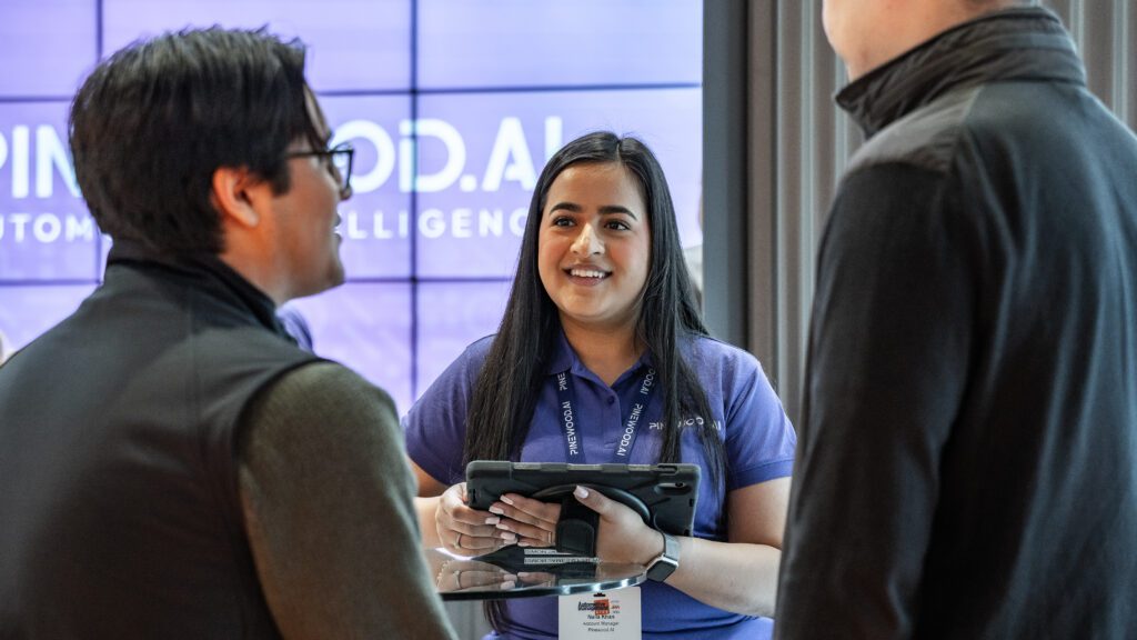 Naila Khan speaking with visitors at the AM Live 2024 Pinewood.AI stand