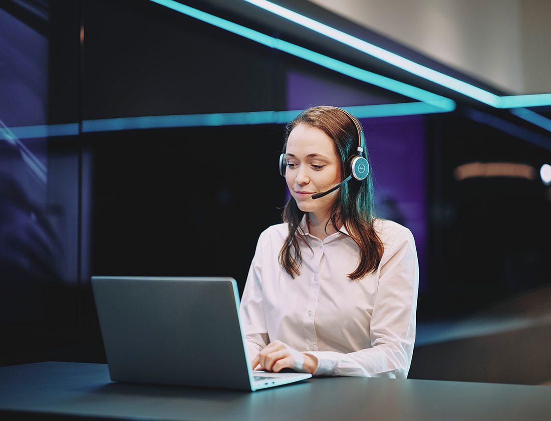 Someone using their laptop and headset as dedicated customer support agent