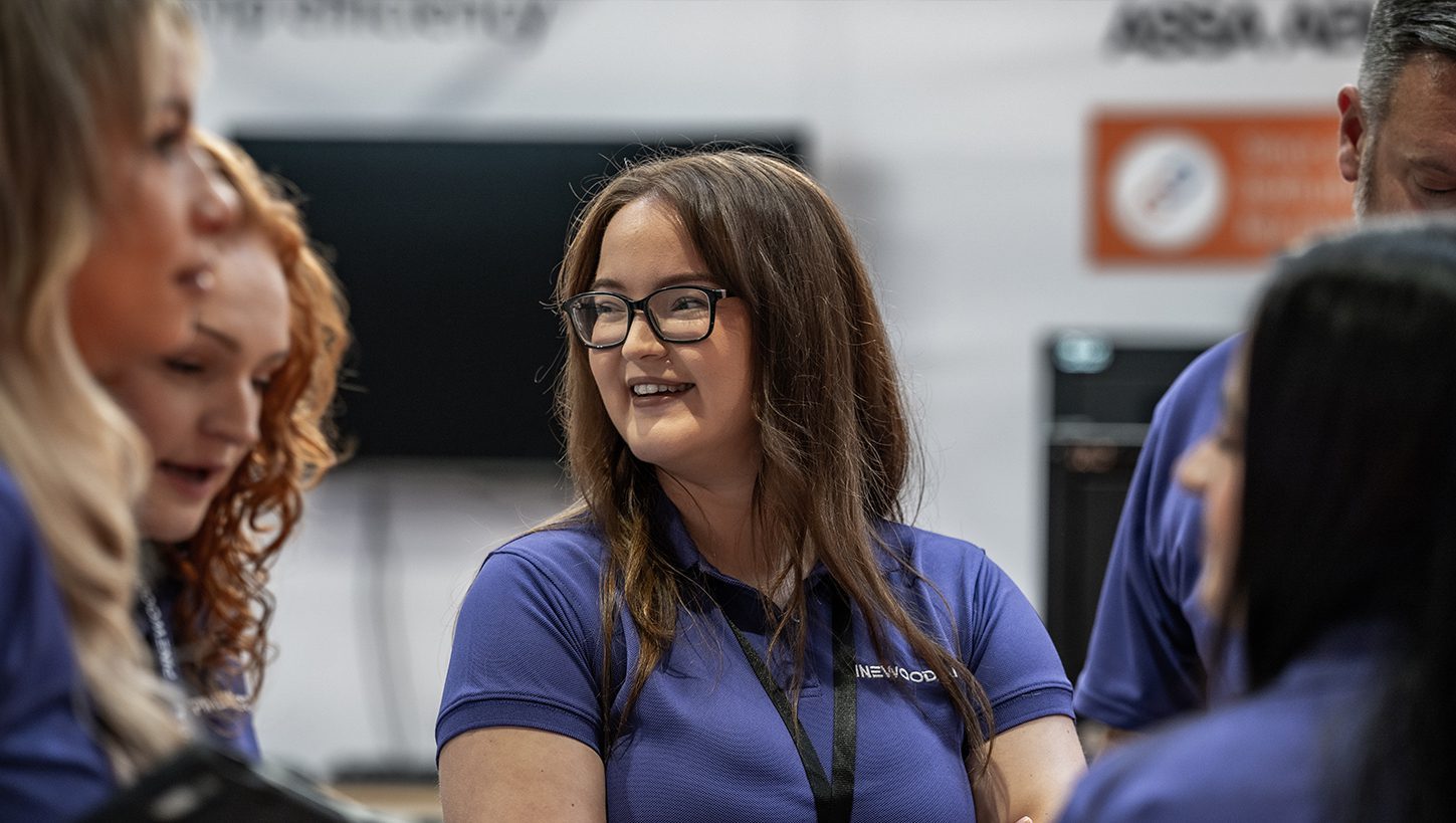 Pinewood employees smiling at an event